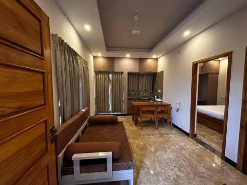 a room with a desk and a bed and a door at GK Homestays - Luxurious Furnished Apartment in Salem