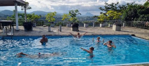 a group of people playing in a swimming pool at Lotus Villa Kandy in Peradeniya