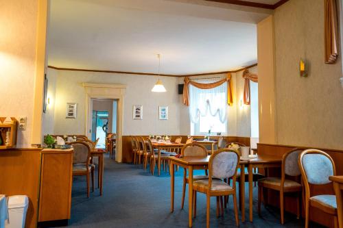 a dining room with wooden tables and chairs at Trip Inn Parkhotel Bad Ems in Bad Ems