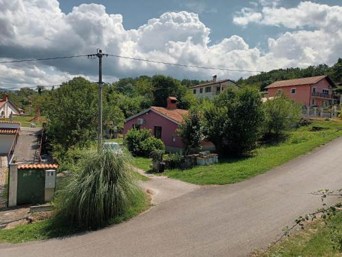 an empty road in a small village with houses at Obmorski oddih in Dekani