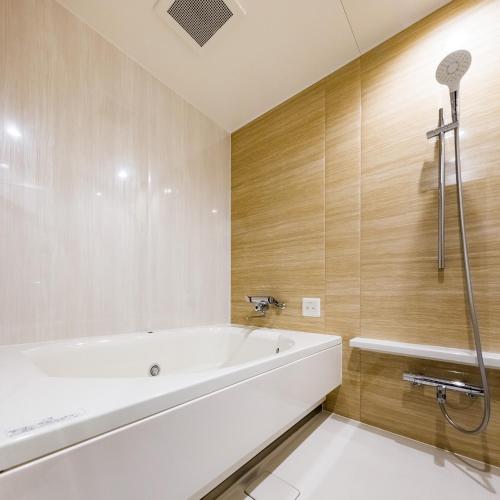 a bathroom with a tub and a shower at Hotel Noir Blanc in Shizuoka