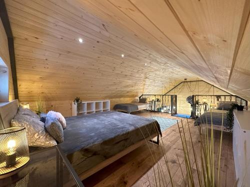a bedroom with a large bed in a wooden room at Grey Sea Rusinowo in Rusinowo