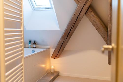 a small attic room with a window and a staircase at Ferienwohnung in der alten Brauerei in Schwäbisch Hall