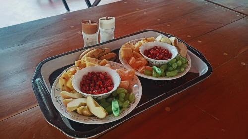 a tray with three bowls of food on a table at The Royal Island in Munroe Island