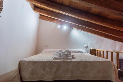 a bedroom with a bed with shoes on it at casetta Leonardo in Posada