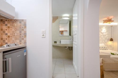 a small bathroom with a sink and a mirror at Sofi pension in Naxos Chora