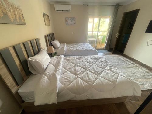 Postel nebo postele na pokoji v ubytování Malek Pyramids Guest House
