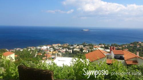 a cruise ship in the ocean next to a city at Pyrgos Traditional Village in Agios Kirykos