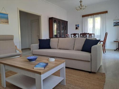a living room with a couch and a coffee table at ENDLESS VIEWS PANTELI LEROS in Panteli