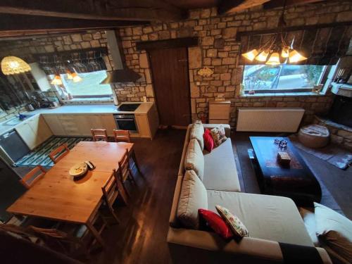 a living room with a couch and a table at Erymanthos country home in Kalavrita