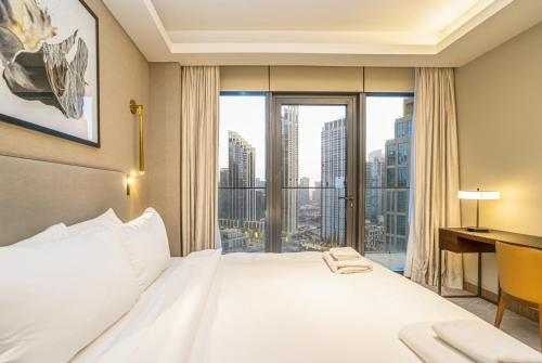 a bedroom with a large bed and a large window at Vacay Lettings Luxury Living Address Opera Downtown in Dubai