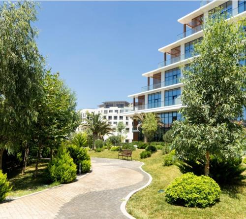 a walkway in a park in front of a building at Sea breeze Lighthouse 2 in Baku