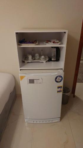 a small white refrigerator sitting in a room at GEM view BOUTIQUE in Cairo