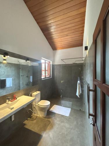 a bathroom with a toilet and a sink at Bokka Almeida in Hikkaduwa
