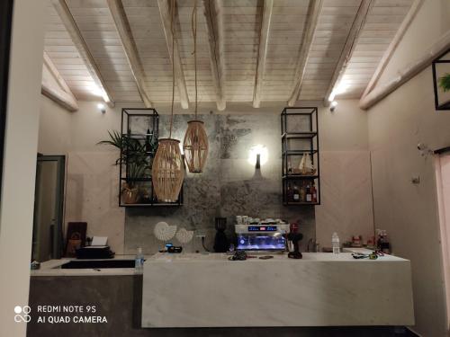 a room with a counter in a room with lights at Olympus Pantheon Luxury Rooms in Plaka Litochorou