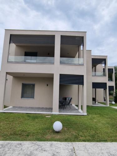 a building with a white ball in front of it at Olympus Pantheon Luxury Rooms in Plaka Litochorou