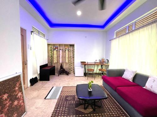 a living room with a couch and a table at Adagaya Villa - Villa With Private Pool, Without Pool in Pantai Cenang