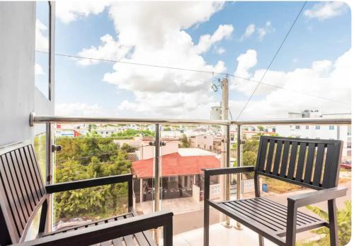 a balcony with two benches and a view of a city at Residencial García 1 apt 3 in La Romana