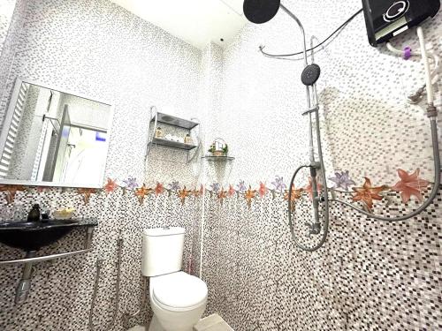 a bathroom with a shower and a toilet in it at Adagaya Villa - Villa With Private Pool, Without Pool in Pantai Cenang