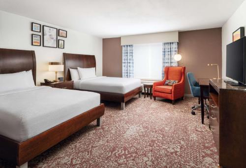 a hotel room with two beds and a desk at Hilton Garden Inn El Paso Airport in El Paso