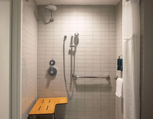a shower with a bench in a bathroom at Hilton Daytona Beach Resort in Daytona Beach