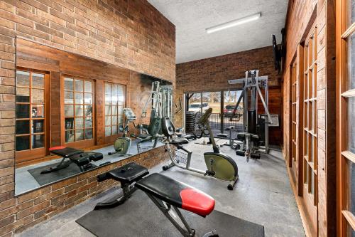 a gym with several exercise bikes and treadmills at Suburban Studios Kansas City Airport North in Platte City