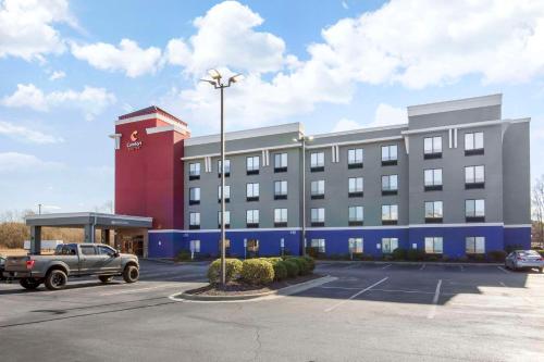 a large building with a parking lot in front of it at Comfort Suites Wilson - I - 95 in Wilson