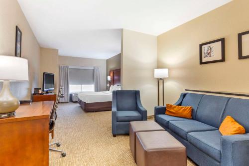 a hotel room with a couch and a bed at Comfort Suites Wilson - I - 95 in Wilson