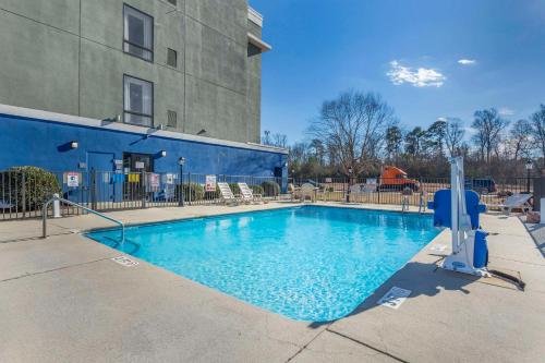a large swimming pool in front of a building at Comfort Suites Wilson - I - 95 in Wilson