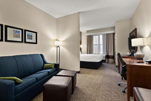 a hotel room with a couch and a bed at Comfort Suites in Nashville