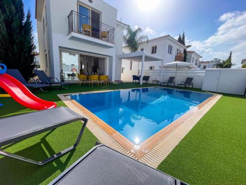 a swimming pool in the yard of a house at Villa Allegra in Protaras