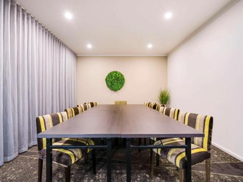 a conference room with a table and chairs at Mercure Albury in Albury