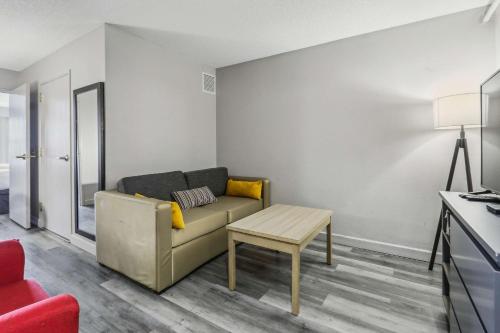 a living room with a couch and a table at Country Inn & Suites by Radisson, Chicago O'Hare South, IL in Bensenville