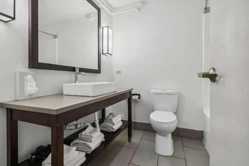 a bathroom with a sink and a toilet at Country Inn & Suites by Radisson, Chicago O'Hare South, IL in Bensenville