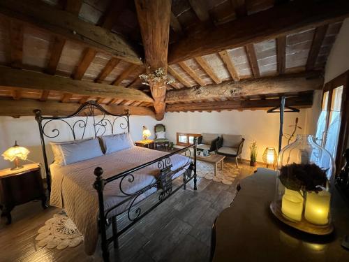 a bedroom with a large bed and a living room at Il Castello di Alberico in Cotignola