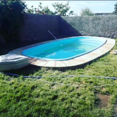 a large blue swimming pool in a yard at Hause la rioja in La Rioja