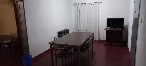 a room with a table and chairs and a television at Hause la rioja in La Rioja