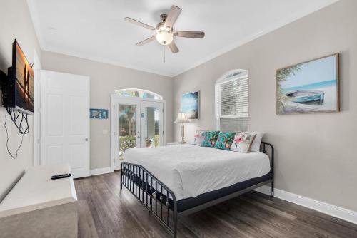 a bedroom with a bed and a ceiling fan at Miramar Magic in Destin