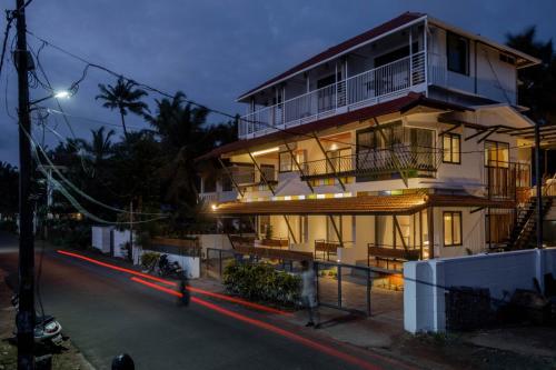 a building on a street at night at Sunfun Beach House in Kannur