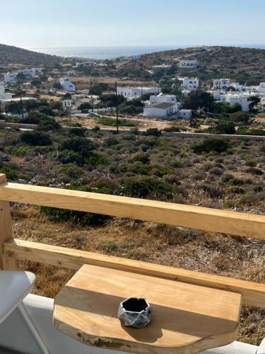 a wooden bench with a hat on top of it at Alexandra’s studios in Iraklia