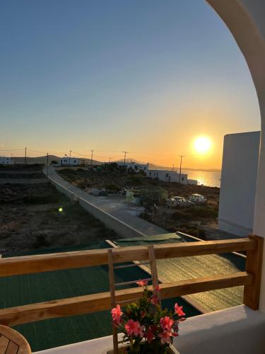 a sunset from a balcony with a view of the ocean at Alexandra’s studios in Iraklia