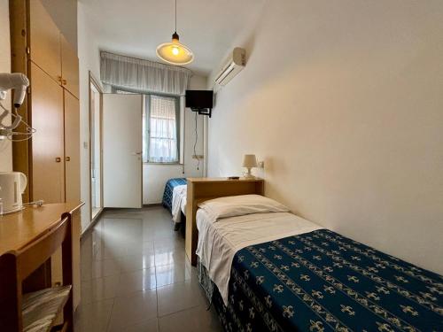 Postel nebo postele na pokoji v ubytování Hotel Iride Suite & Breakfast- ideale per famiglie e coppie