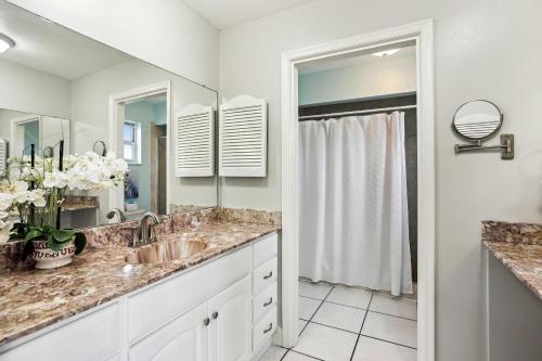 a bathroom with a sink and a mirror at Sea Breeze 401 in St. Pete Beach