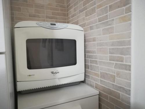 a television sitting on top of a toilet in a bathroom at Casa Marina in Carloforte