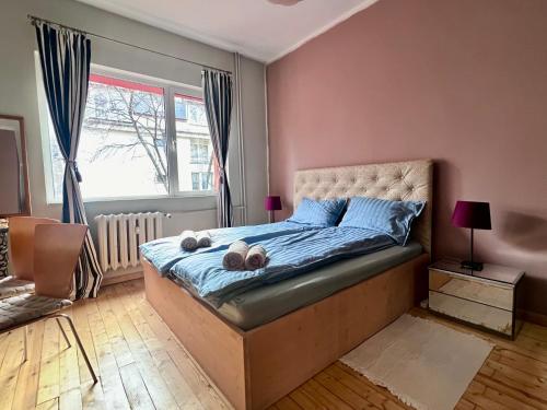 a bedroom with a bed with two pillows on it at Eternity Apartment: Award-Winning Design in the Heart of the City Center in Sofia