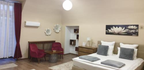 a bedroom with a bed and a table and chairs at IMPERIAL ROOMS - ULTRACENTRAL - jacuzzi cu hidromasaj in Oradea