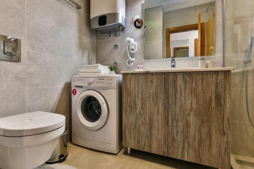a bathroom with a washing machine and a sink at Victoria Apartments in Budva