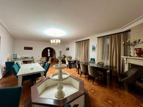 a living room with tables and chairs and a dining room at Family Hotel in Yerevan