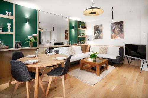 a living room with a table and a couch at Appartement standing -T3- Centre in Écully