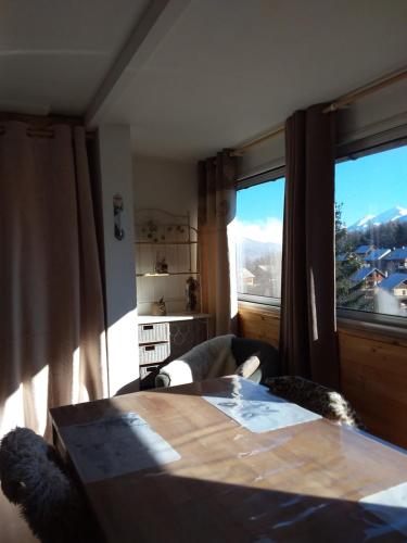 a room with a table and a large window at ETOILE D ARGENS Chalet N 2 in Laye